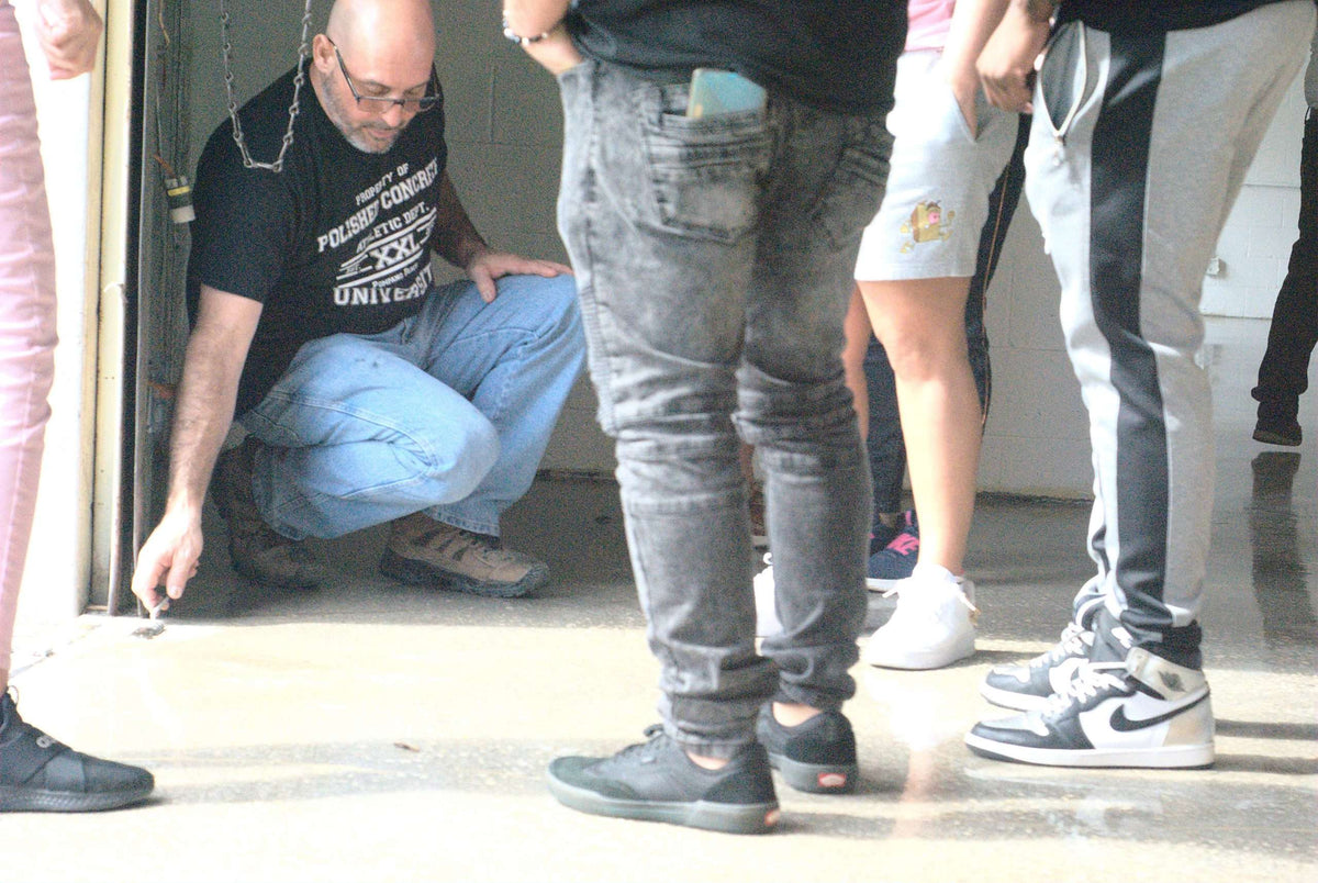 An image showing a professional assessing concrete before testing.