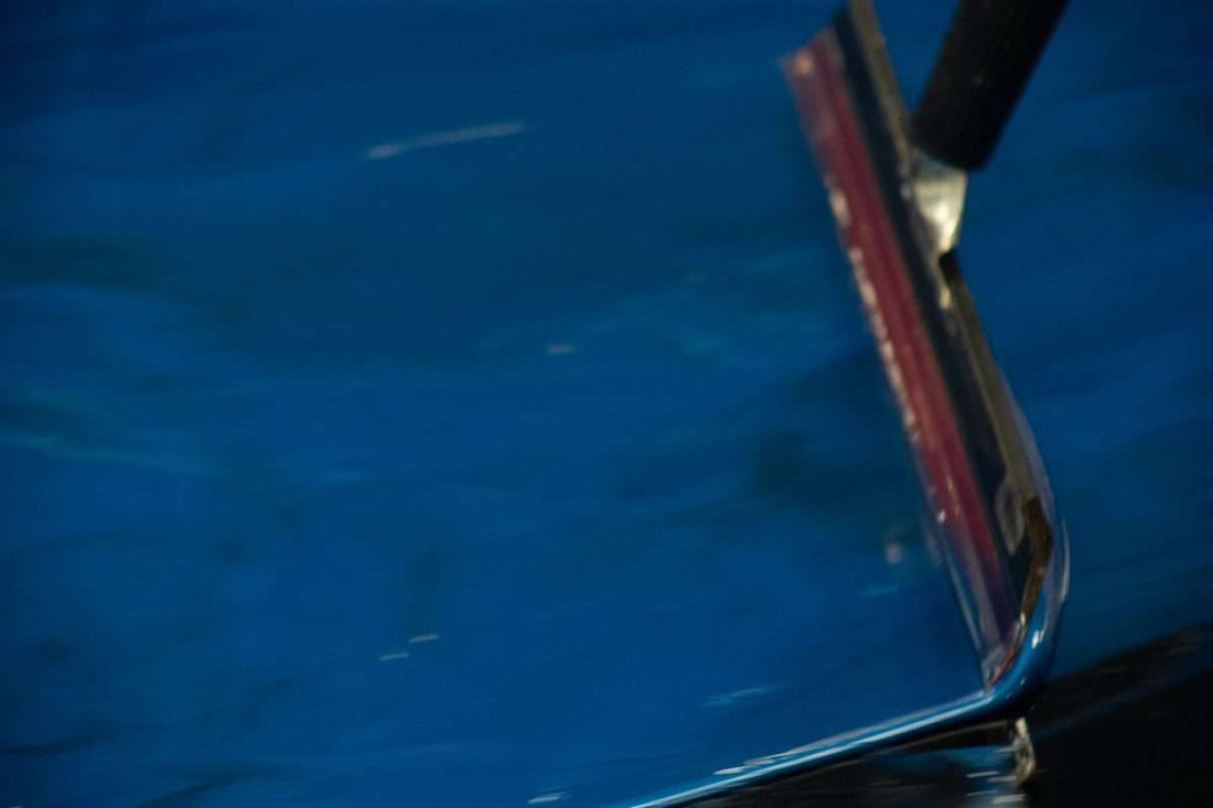 An image of a deep blue epoxy resin layer being installed.