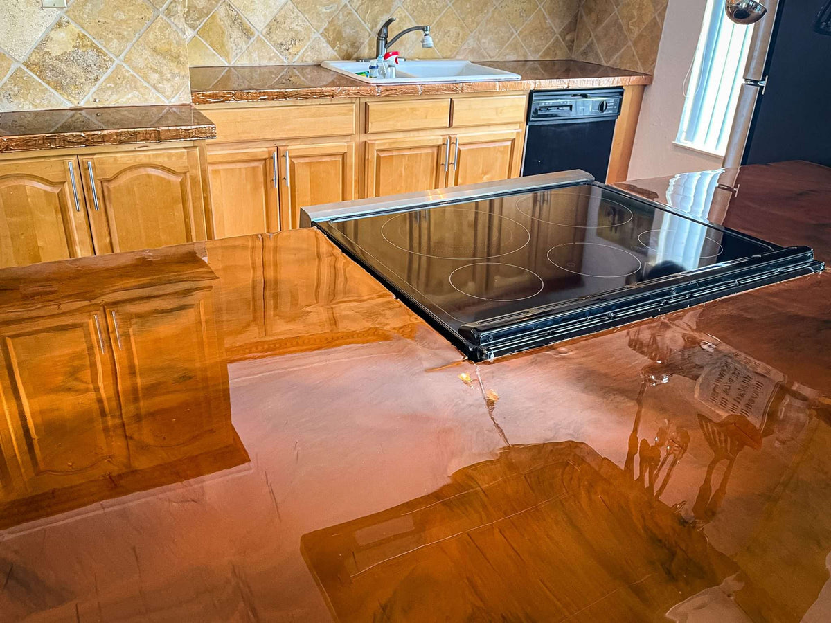 Epoxy countertops reflecting on their glossy surfaces in a residential kitchen.