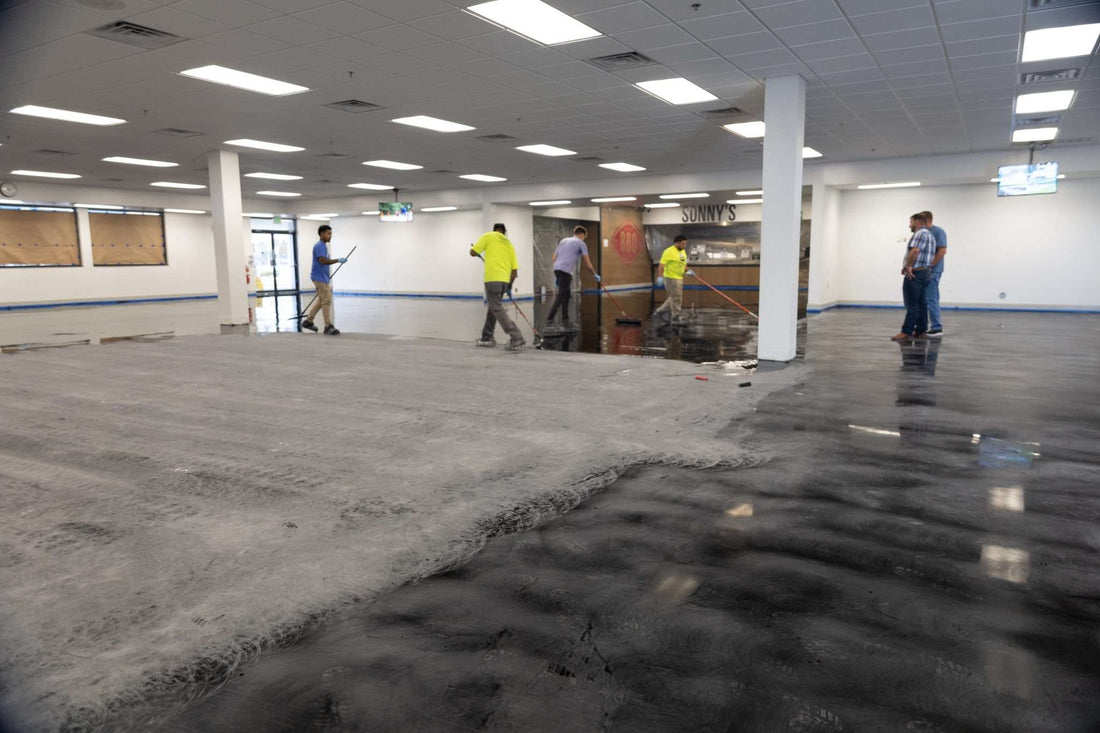 Contractors installing large-scale epoxy projects in prepared sections.
