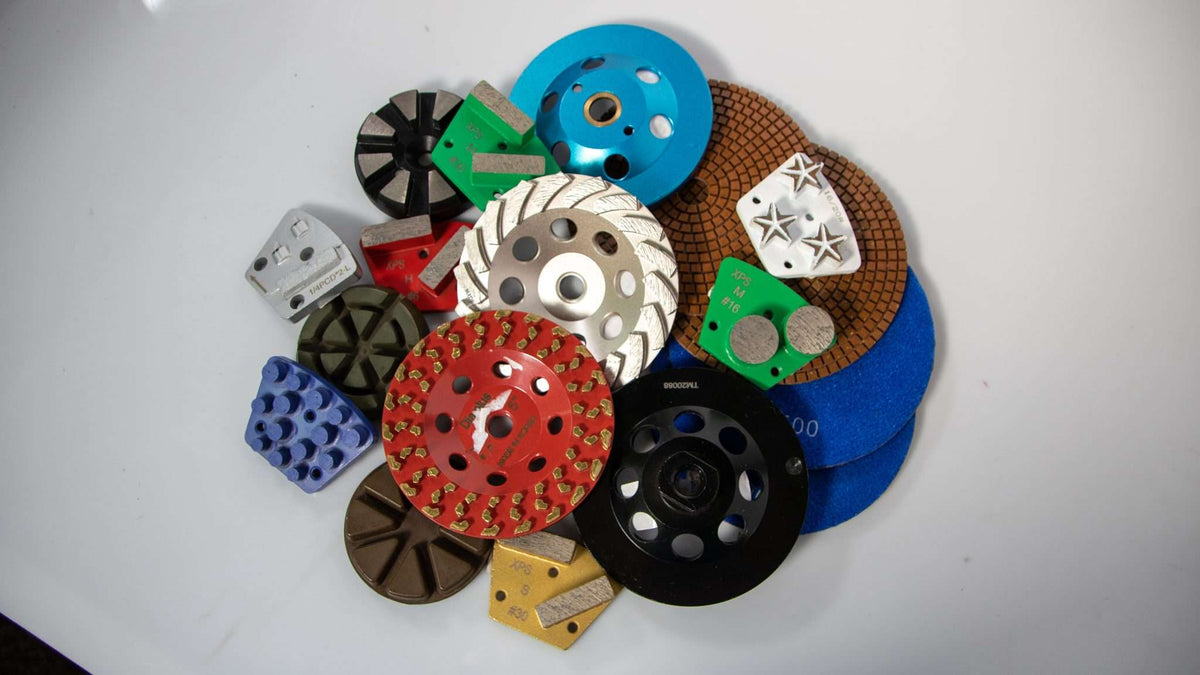 An assortment of diamond concrete grinders, epoxy resin grinding heads, coating removal heads, and other diamond PCD and grinding tools.