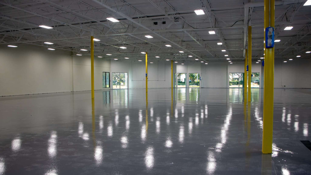A large warehouse with a glossy epoxy floor installed.