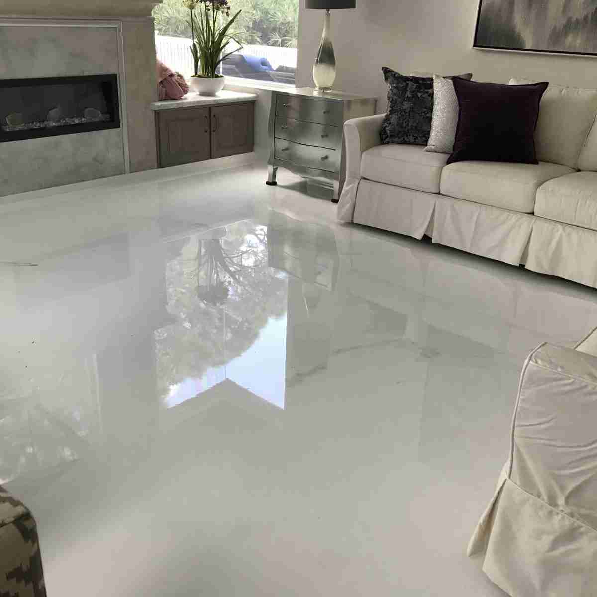 An image showing an epoxy floor installed in a residential living room mimicking a marble slab.