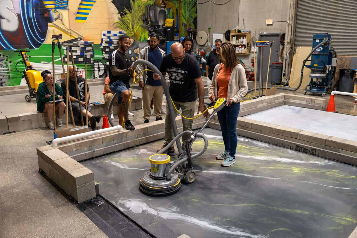 An epoxy resin certification course taught by an installer using a polishing machine.