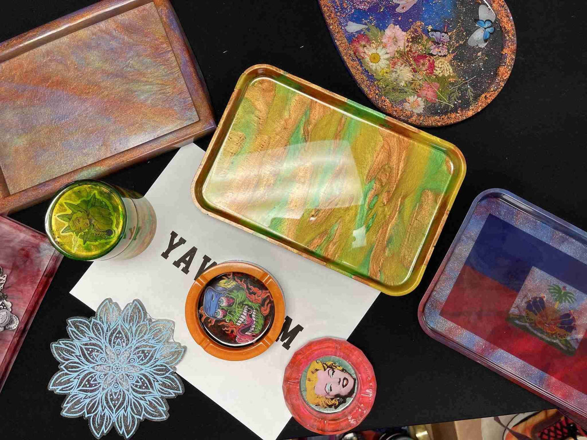 DIY epoxy resin arts and crafts laid out on a table.