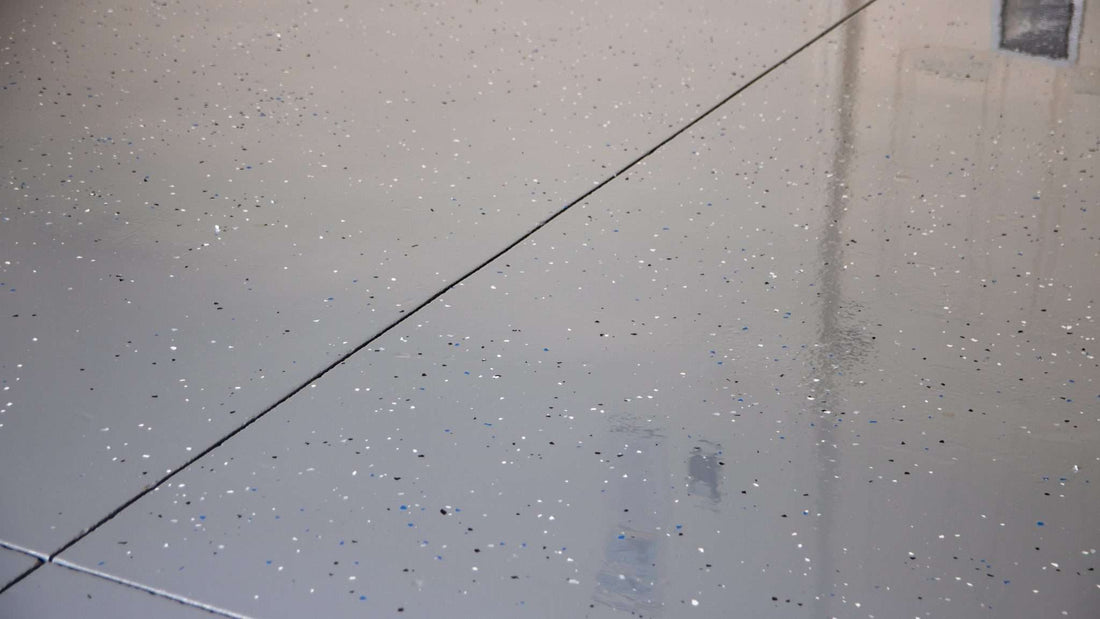 A vinyl flake epoxy resin floor installed in a garage carport.