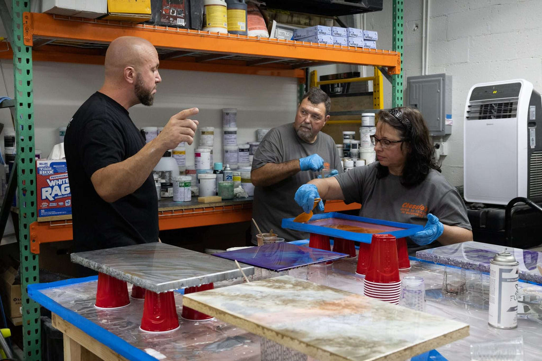 Flooring contractors in training to work with epoxy resin with professionals.