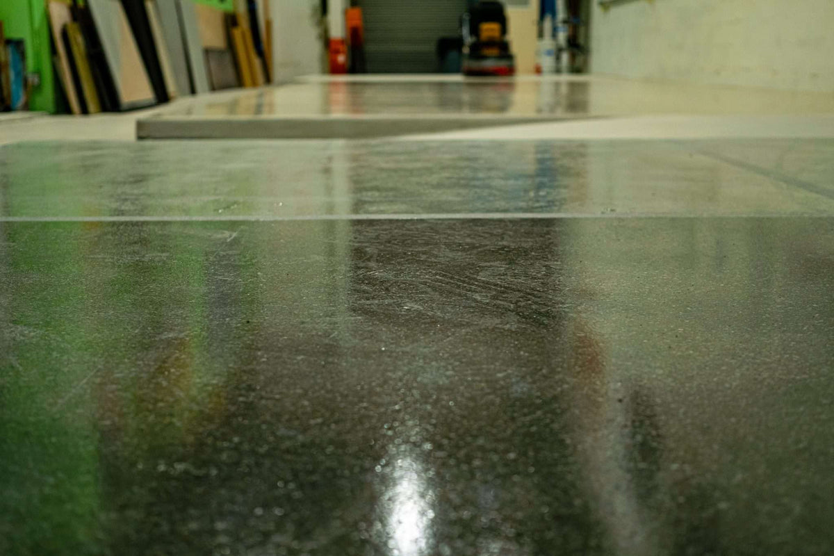 Slabs of polished concrete displayed across a warehouse floor.