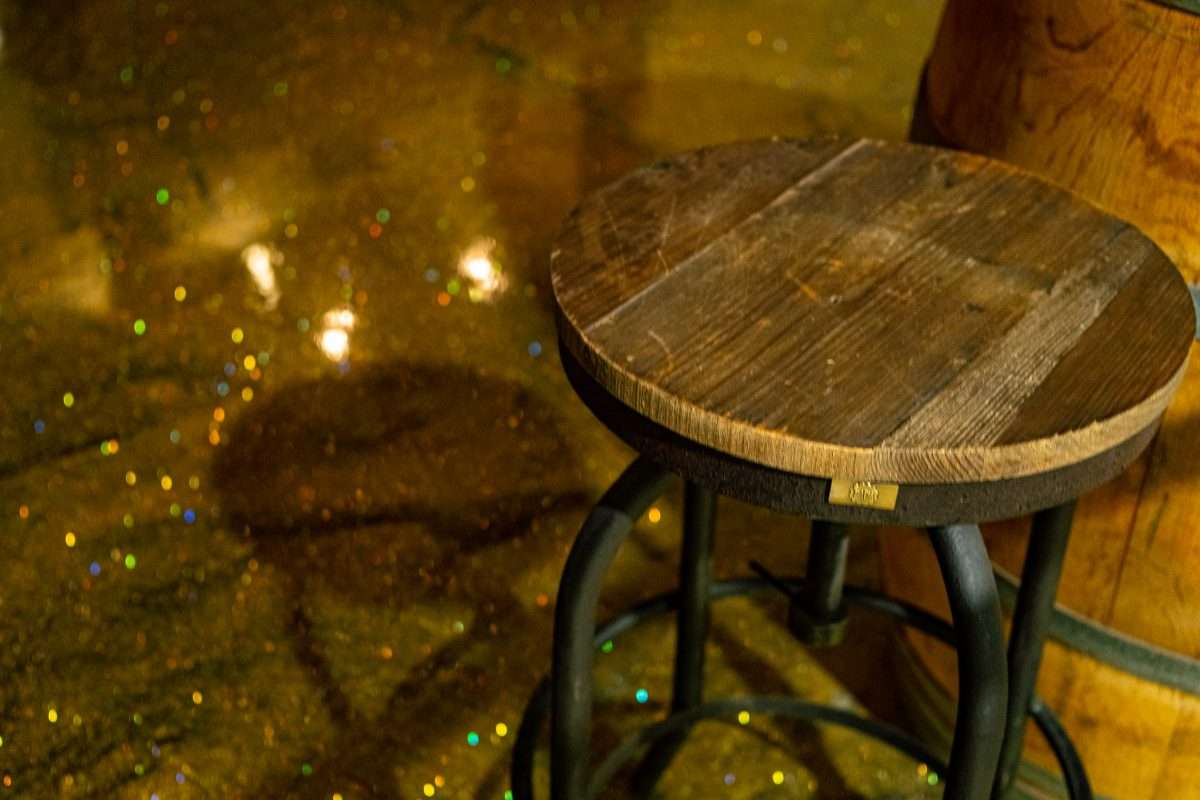 An image showing a beautiful glitter epoxy floor design installed in a bar floor.