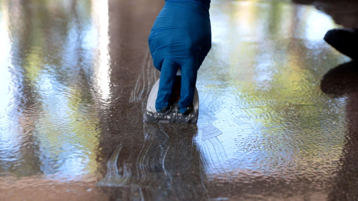 Nitrile gloves used to safely wipe and prepare epoxy resin flooring.