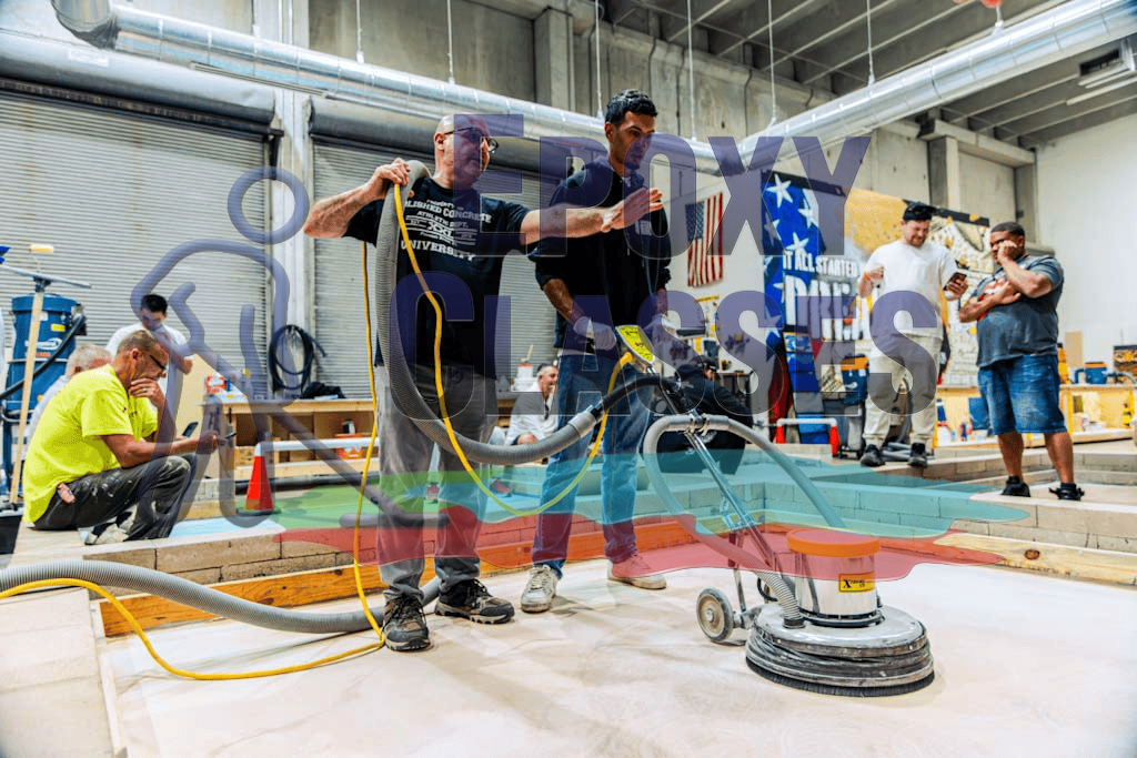 Hands-on epoxy training in a warehouse setting with student contractors.