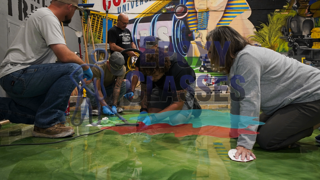 Student contractors in epoxy courses installing a metallic green resinous coating.