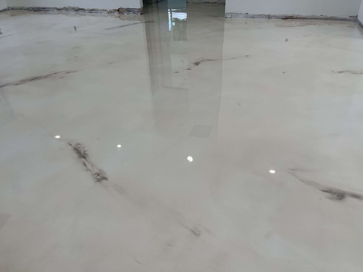 An image showing an installed pearl white metallic epoxy floor.